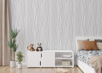 Low platform bed backed by a delicate striped pattern wallpaper