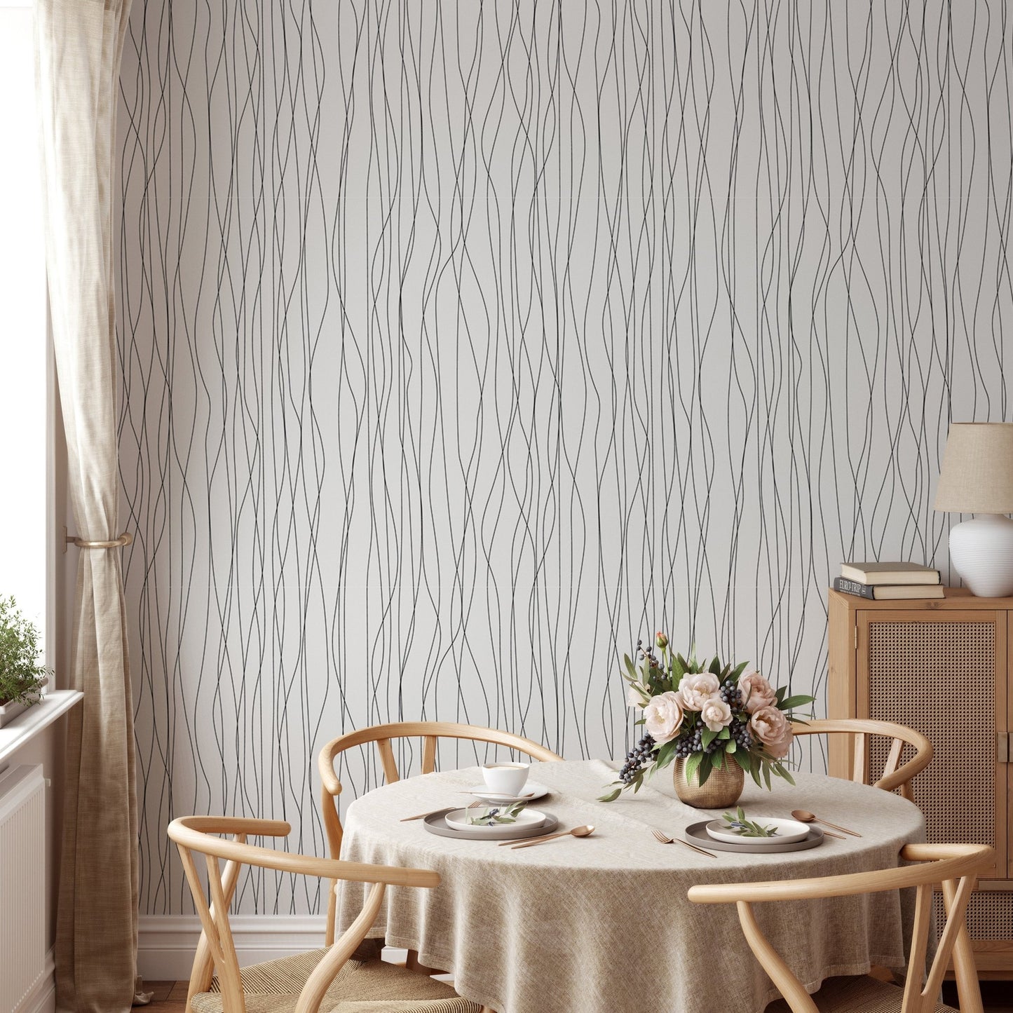Round dining table set against a wavy striped wallpaper.