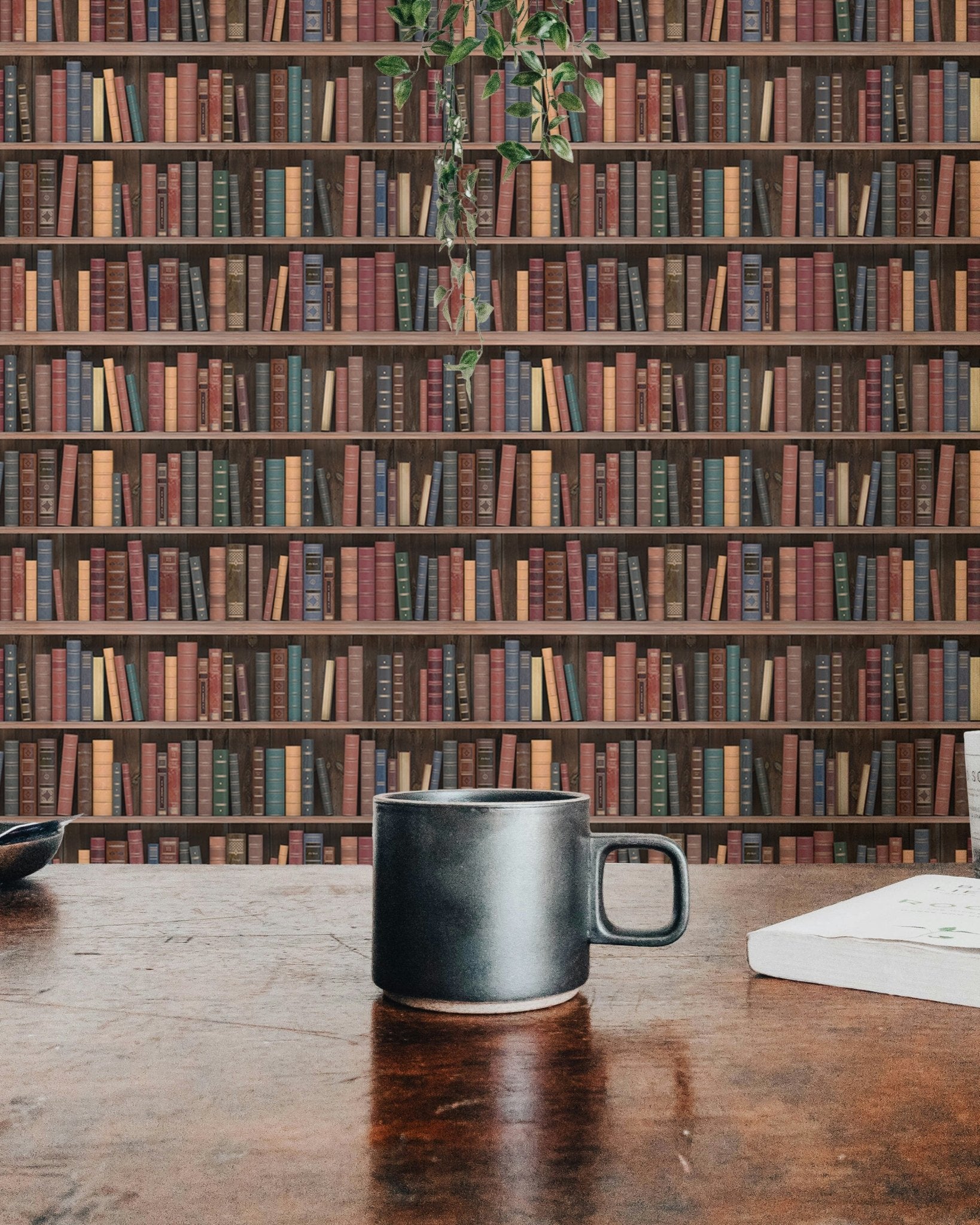 Dark brown book pattern wall mural in a cafe setting with a coffee mug in view.