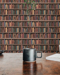 Dark brown book pattern wall mural in a cafe setting with a coffee mug in view.