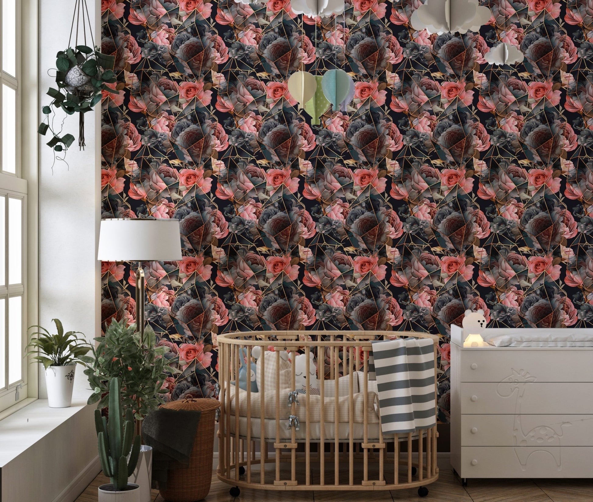 Floral wallpaper in a nursery with a wooden crib and white dresser