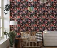 Floral wallpaper in a nursery with a wooden crib and white dresser