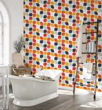 Bathroom interior featuring a white bathtub and geometric tile design wall mural.