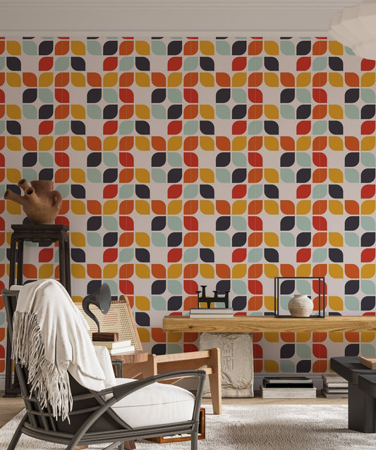 Retro geometric wall mural in a study room with a wooden desk and black chair.