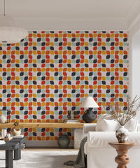 Living area wall mural featuring orange and teal geometric shapes behind a white sofa.