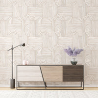Sideboard area wallpaper with neutral geometric lines and a floor lamp.
