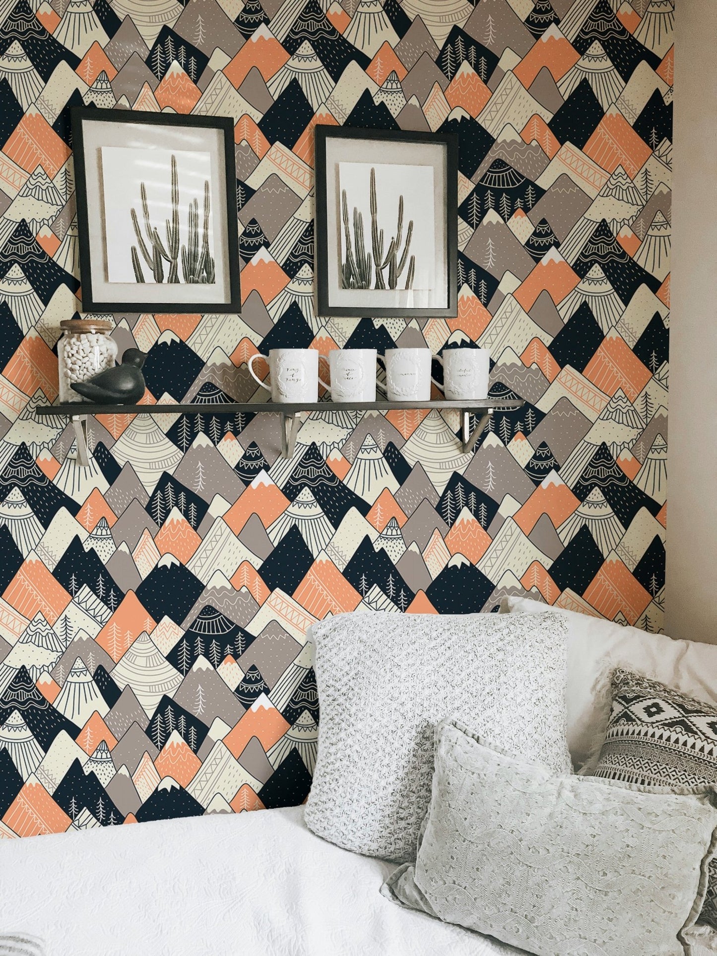 Grey and orange geometric wallpaper in a living area with framed art.