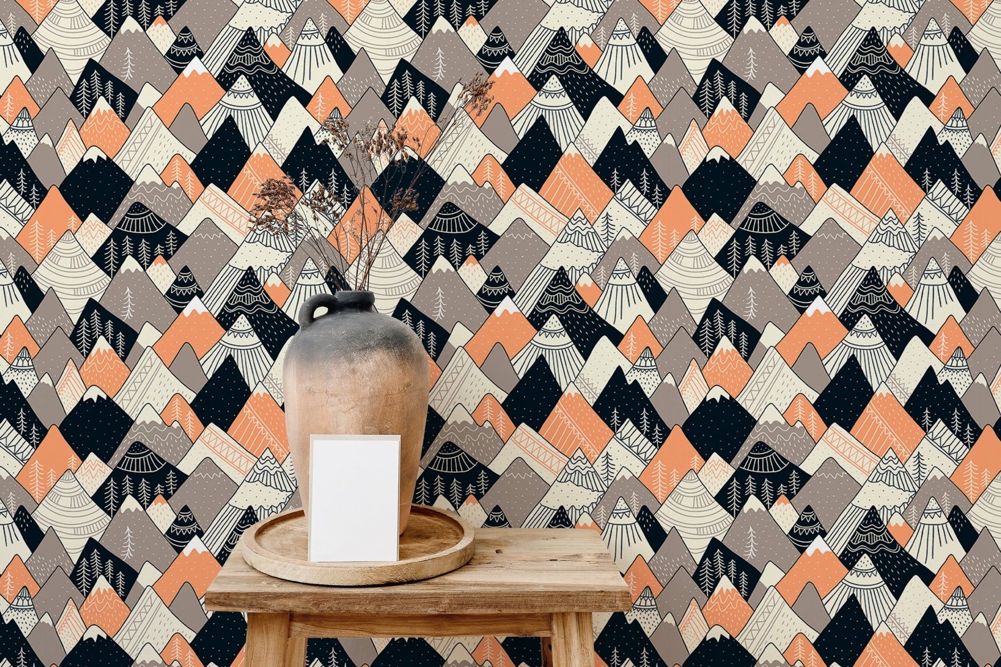 Abstract alpine pattern wallpaper behind a wooden desk and ceramic vase.