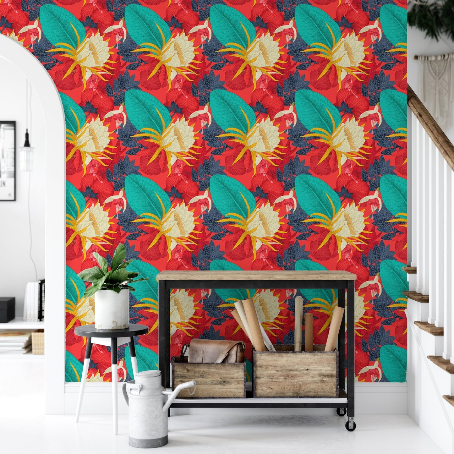 Tropical wallpaper in a hallway with a black metal console and plants.