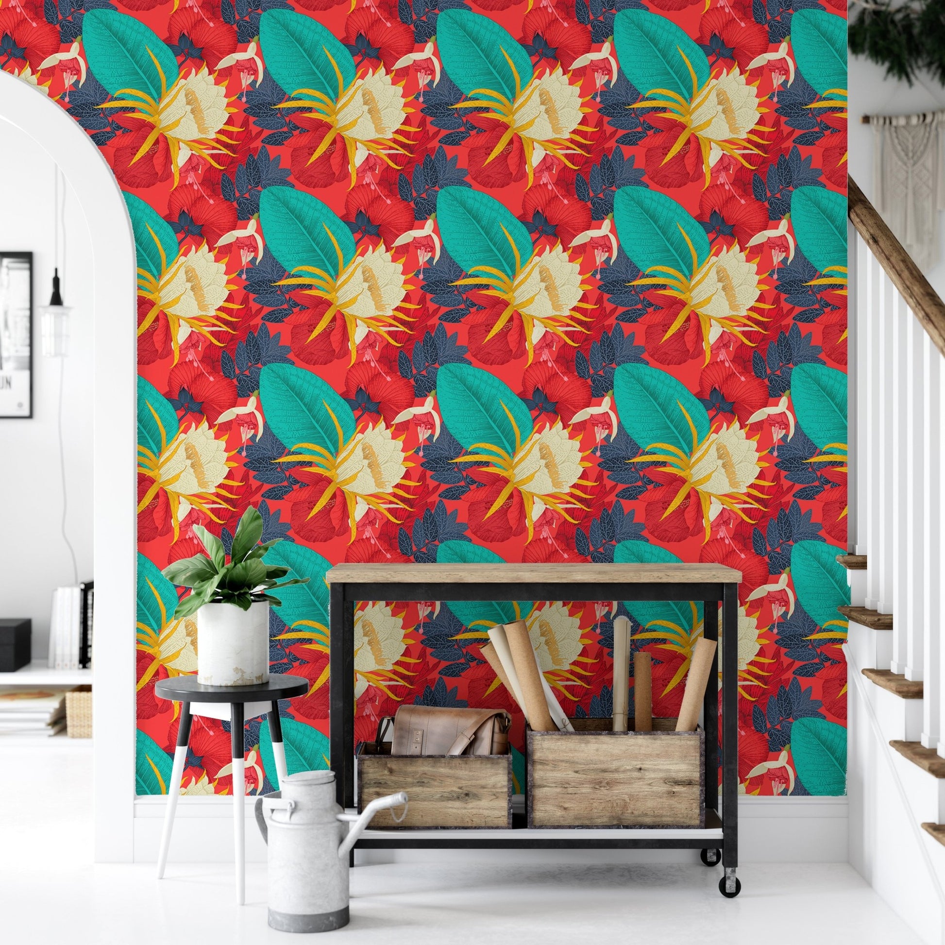Tropical wallpaper in a hallway with a black metal console and plants.
