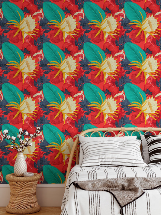 Tropical floral wallpaper with red background behind a wooden bed frame.