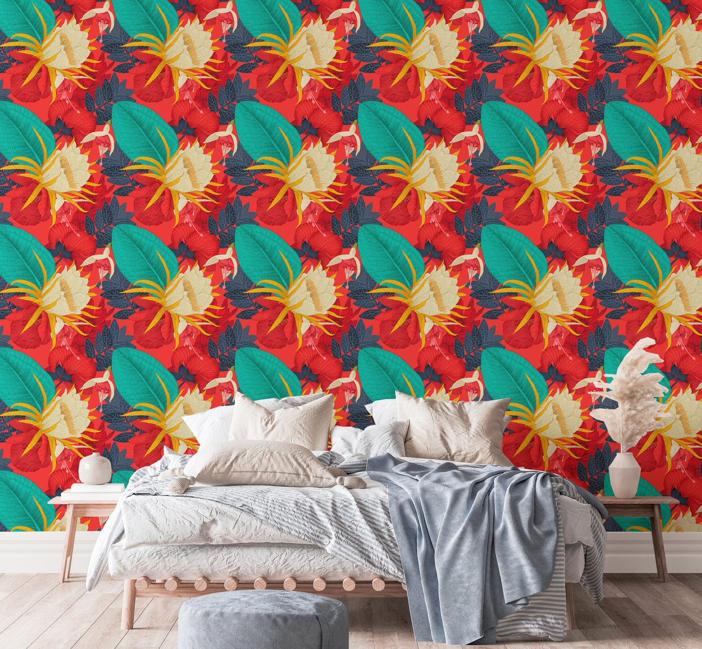 Floral wallpaper with red and yellow tones in a bedroom with white bedding.