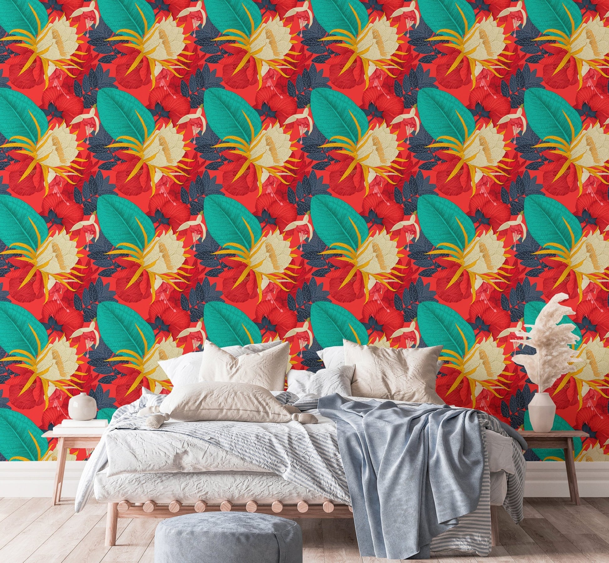 Floral wallpaper with red and yellow tones in a bedroom with white bedding.