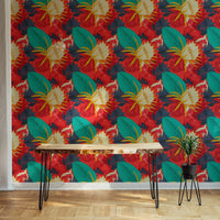 Red background wallpaper in a home area with a wooden desk and black chair.