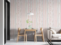 Modern dining space featuring pink striped wallpaper and wooden chairs.