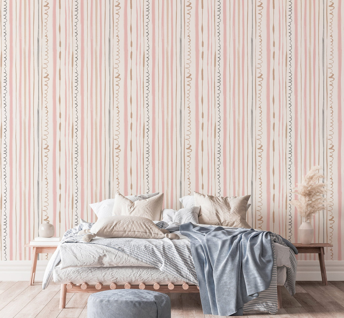 Large bedroom wallpaper with pink vertical lines behind a grey bed.