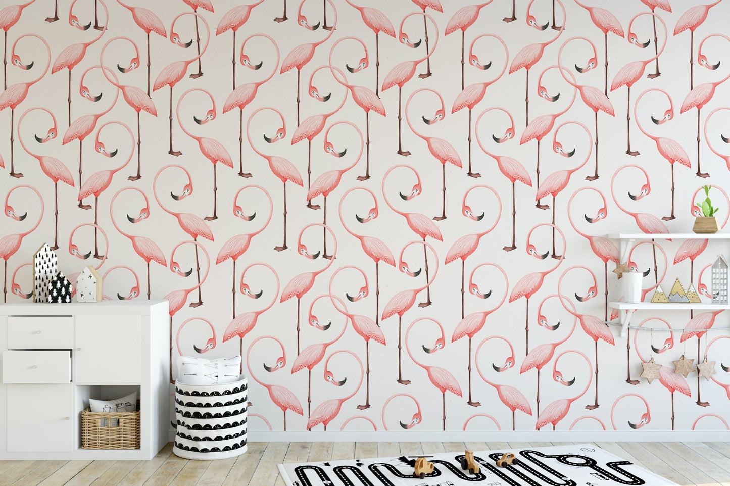 Minimalist nursery area with pink flamingo wallpaper and wooden desk.