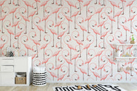 Minimalist nursery area with pink flamingo wallpaper and wooden desk.