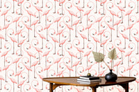 Seamless flamingo wallpaper behind a low coffee table with dried pampas grass.