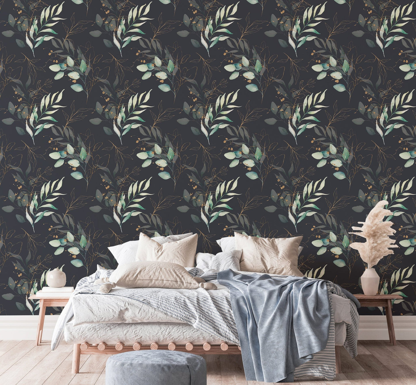 Floral wallpaper behind a bed with light blue and white linens in a bedroom.