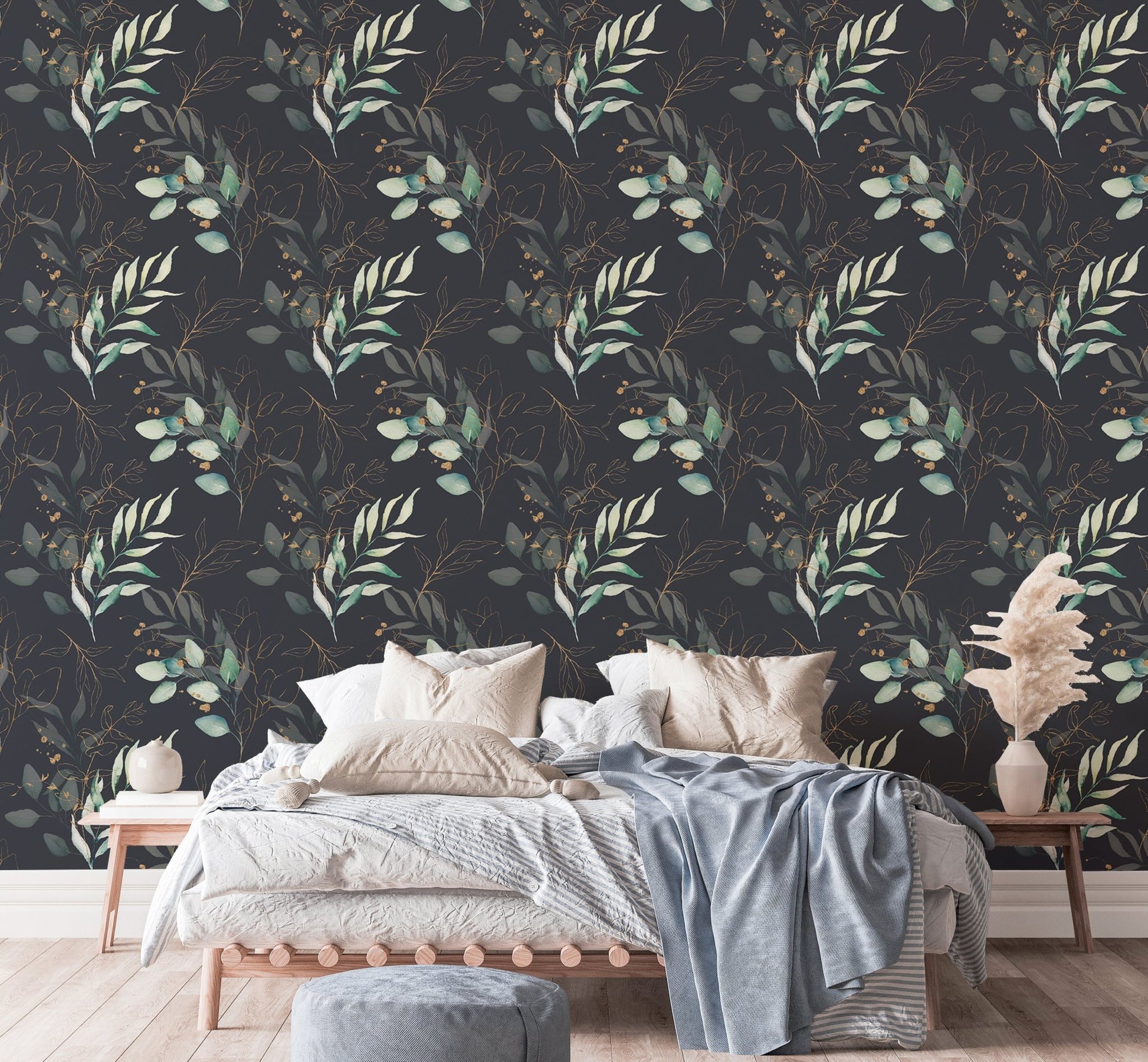 Floral wallpaper behind a bed with light blue and white linens in a bedroom.