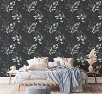 Floral wallpaper behind a bed with light blue and white linens in a bedroom.