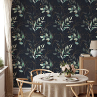 Botanical leaves wallpaper in a kitchen setting with a circular wooden dining table.