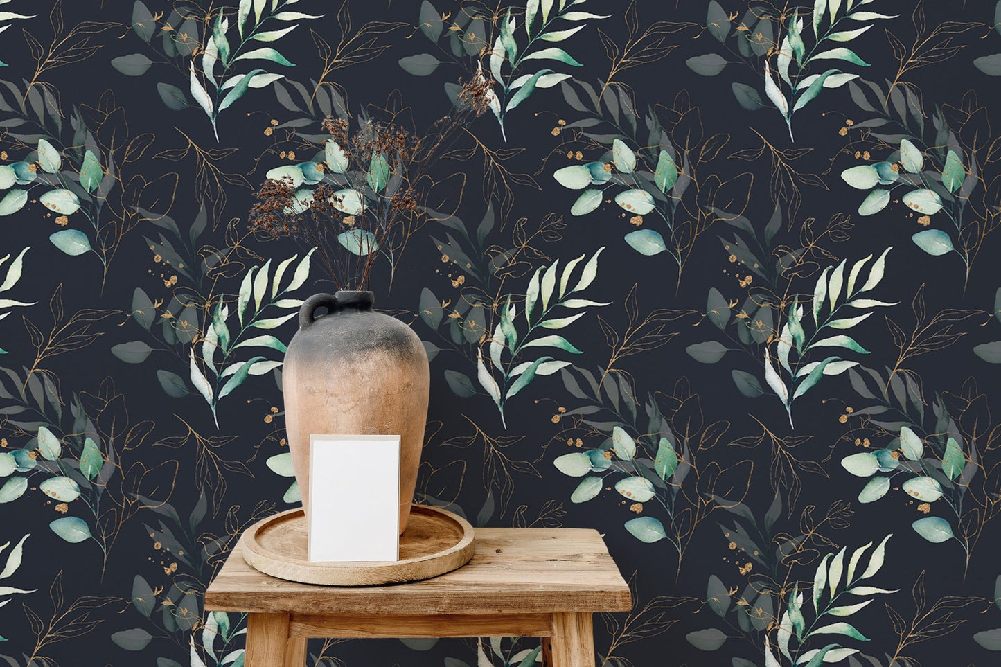 Botanical floral wallpaper behind a wooden shelf with a ceramic vase and white sofa.
