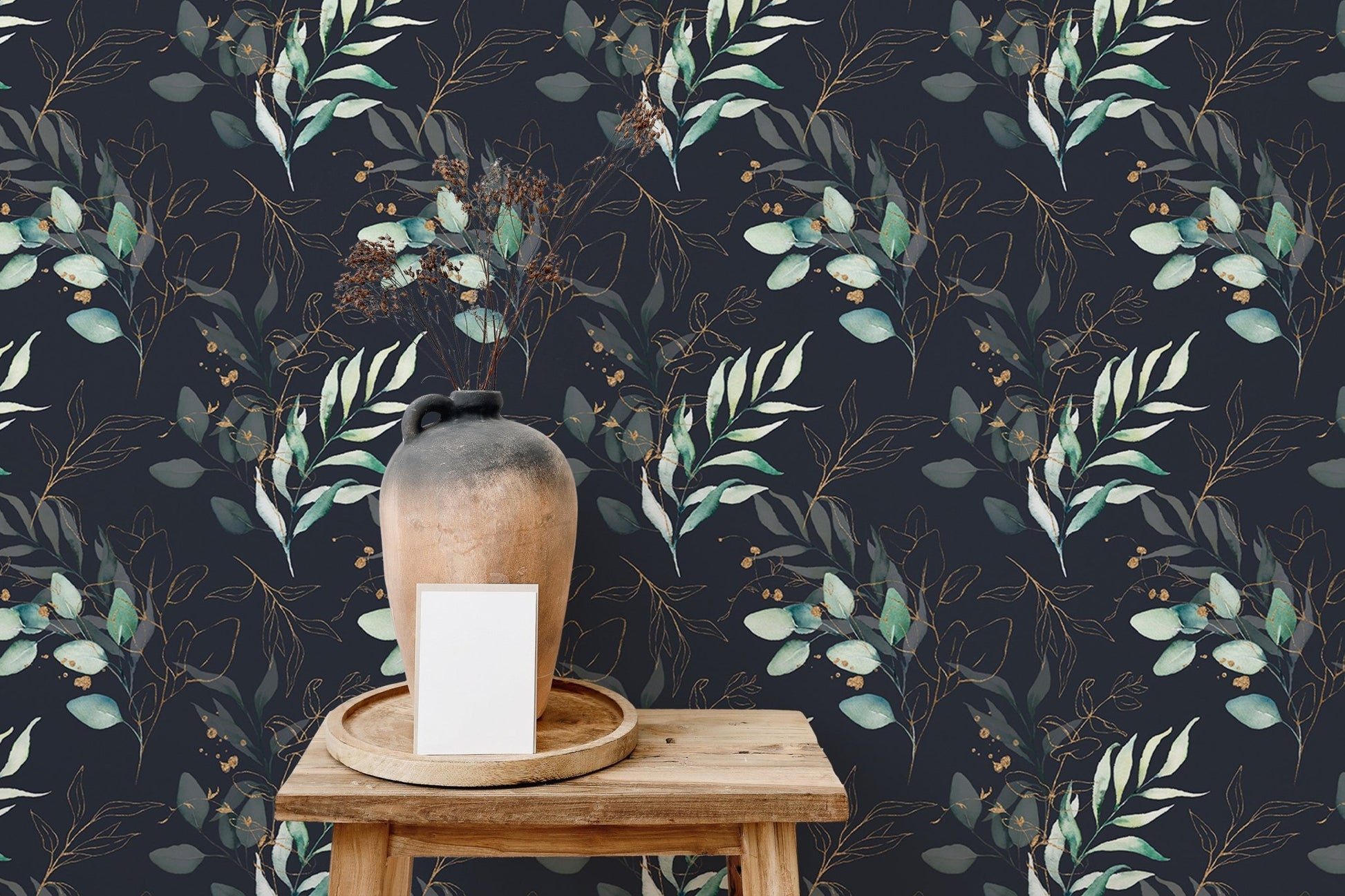 Botanical floral wallpaper behind a wooden shelf with a ceramic vase and white sofa.