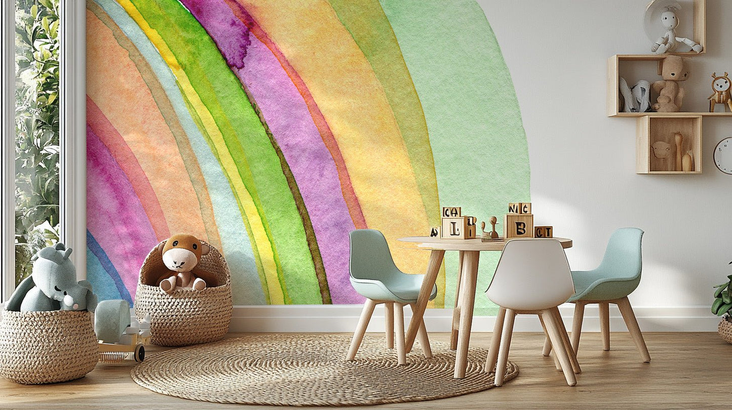 Rainbow style wall mural behind white table and chairs for play area.