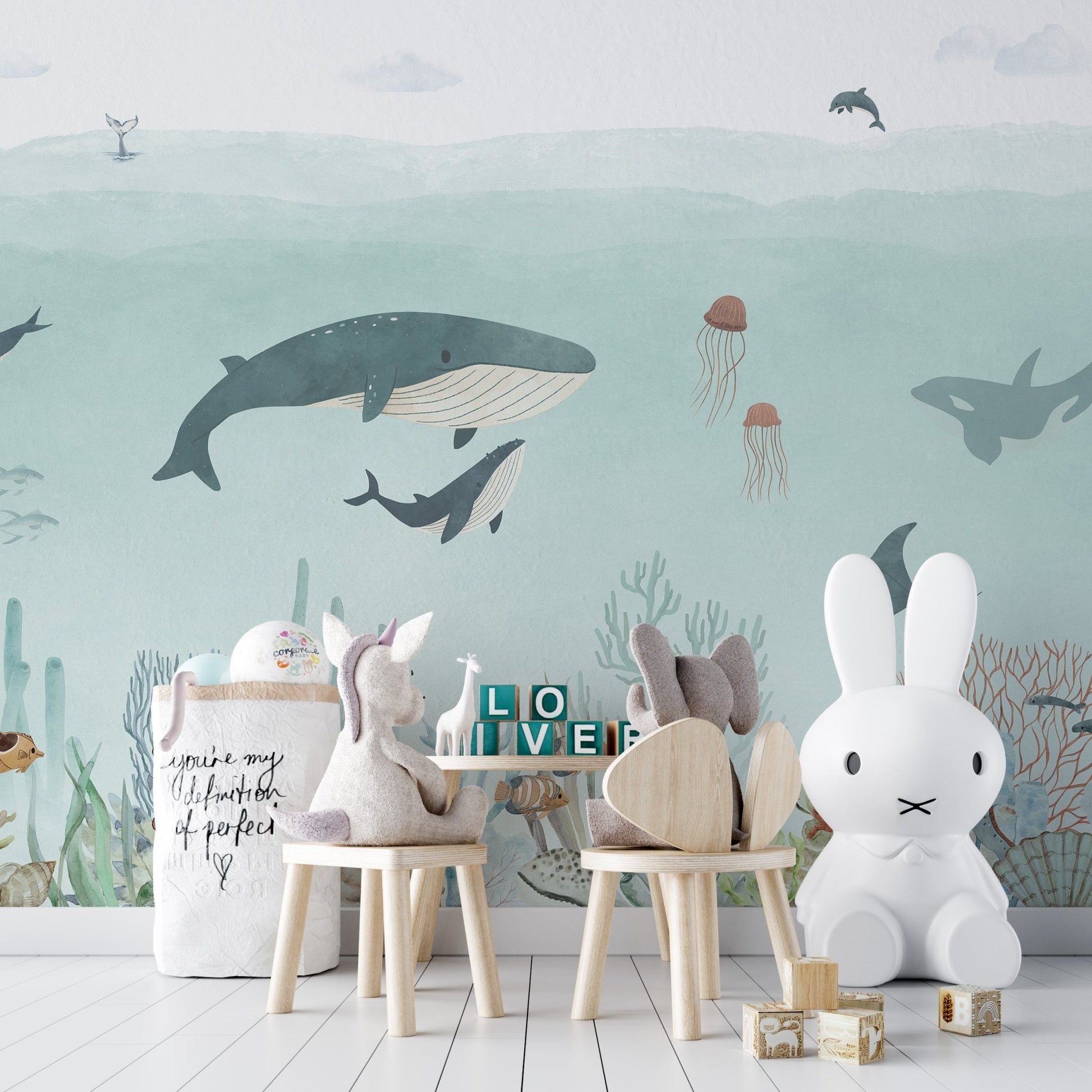 Detailed sea wallpaper showing jellyfish and narwhals on a light blue base.