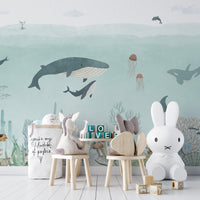 Detailed sea wallpaper showing jellyfish and narwhals on a light blue base.