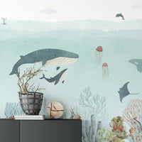 Artistic ocean sensational wallpaper with coral formations and schools of fish.