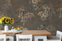 Brown Blossom wall mural as a backdrop for a wooden dining table and yellow flowers.