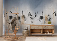 Abstract crane bird wall mural in a room with a wicker chair and wooden console.
