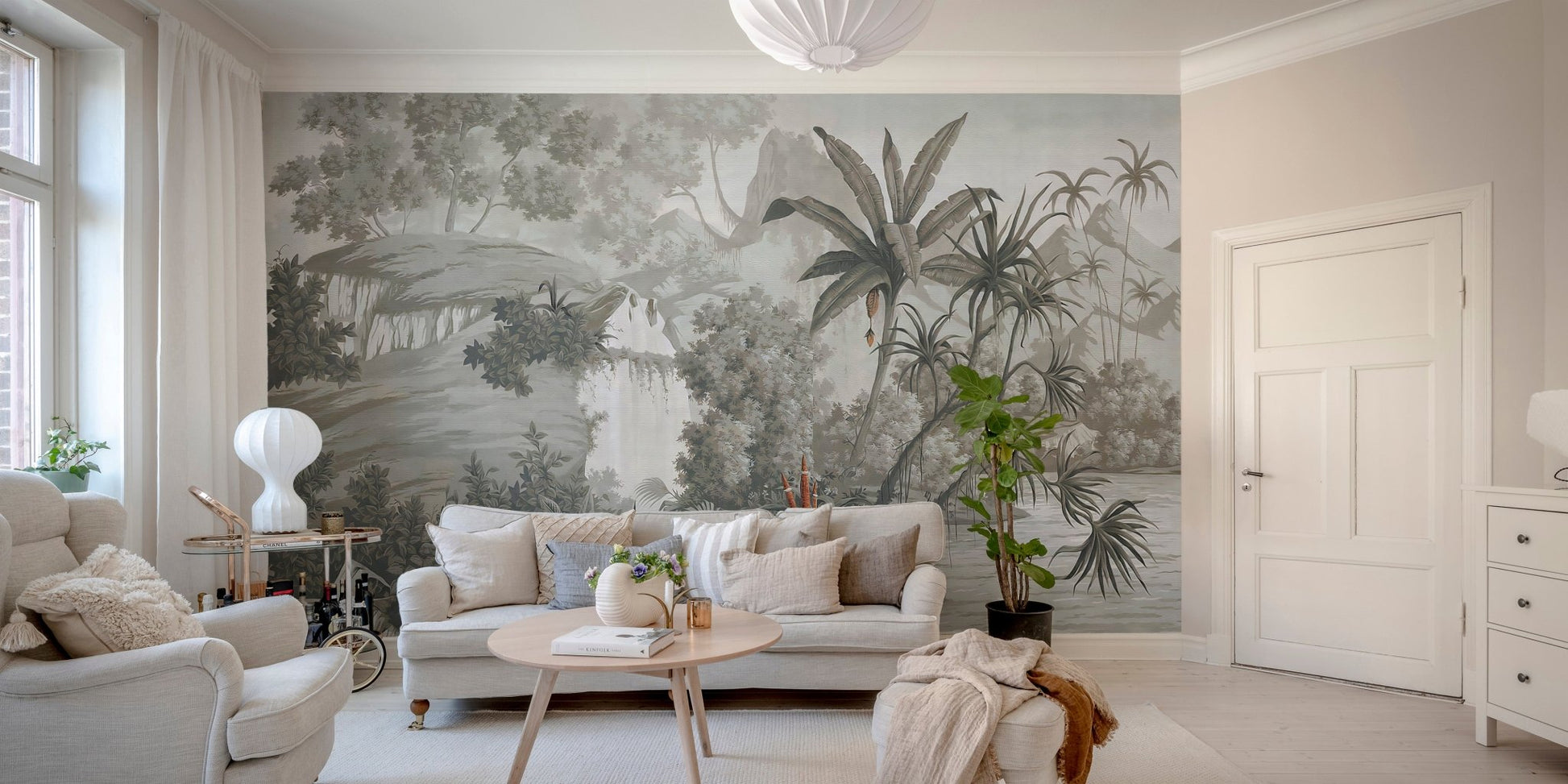 Grey tropical woodland wall mural featuring palm trees behind a white sofa in living room.