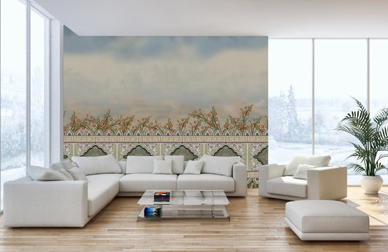 Large white sectional sofa in a sunlit room with floral landscape wall murals.