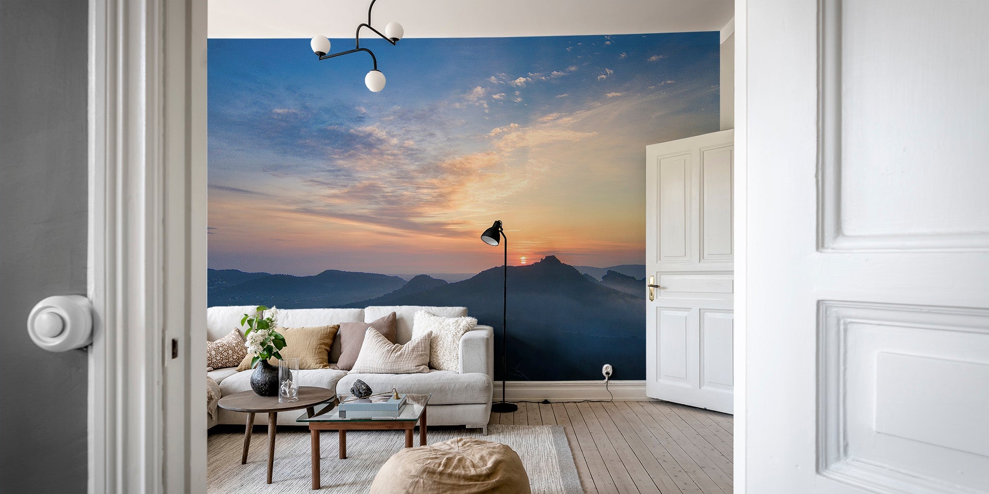 Serene sunset over mountains wallpaper with orange horizon and misty hills.