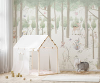 Light green forest theme wall mural in a child's room.