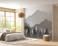 Bright bedroom with a mountain range wall mural and wooden window frames.