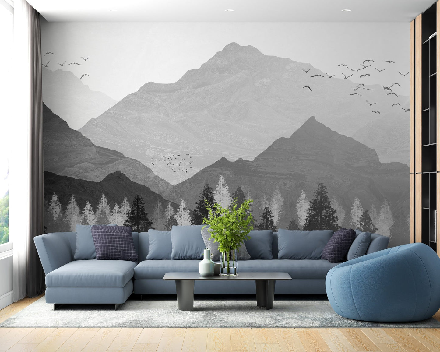 Blue sectional sofa set against a grey mountain landscape wall mural.