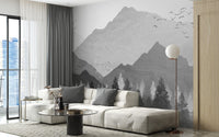 Spacious living area with white furniture and mountain landscape wall mural.