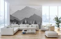 Grey and white mountain wall mural behind a comfortable sofa arrangement.