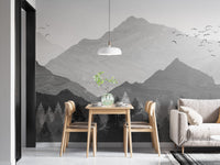 Minimalist dining area with a mountain peak wall mural and wooden furniture.
