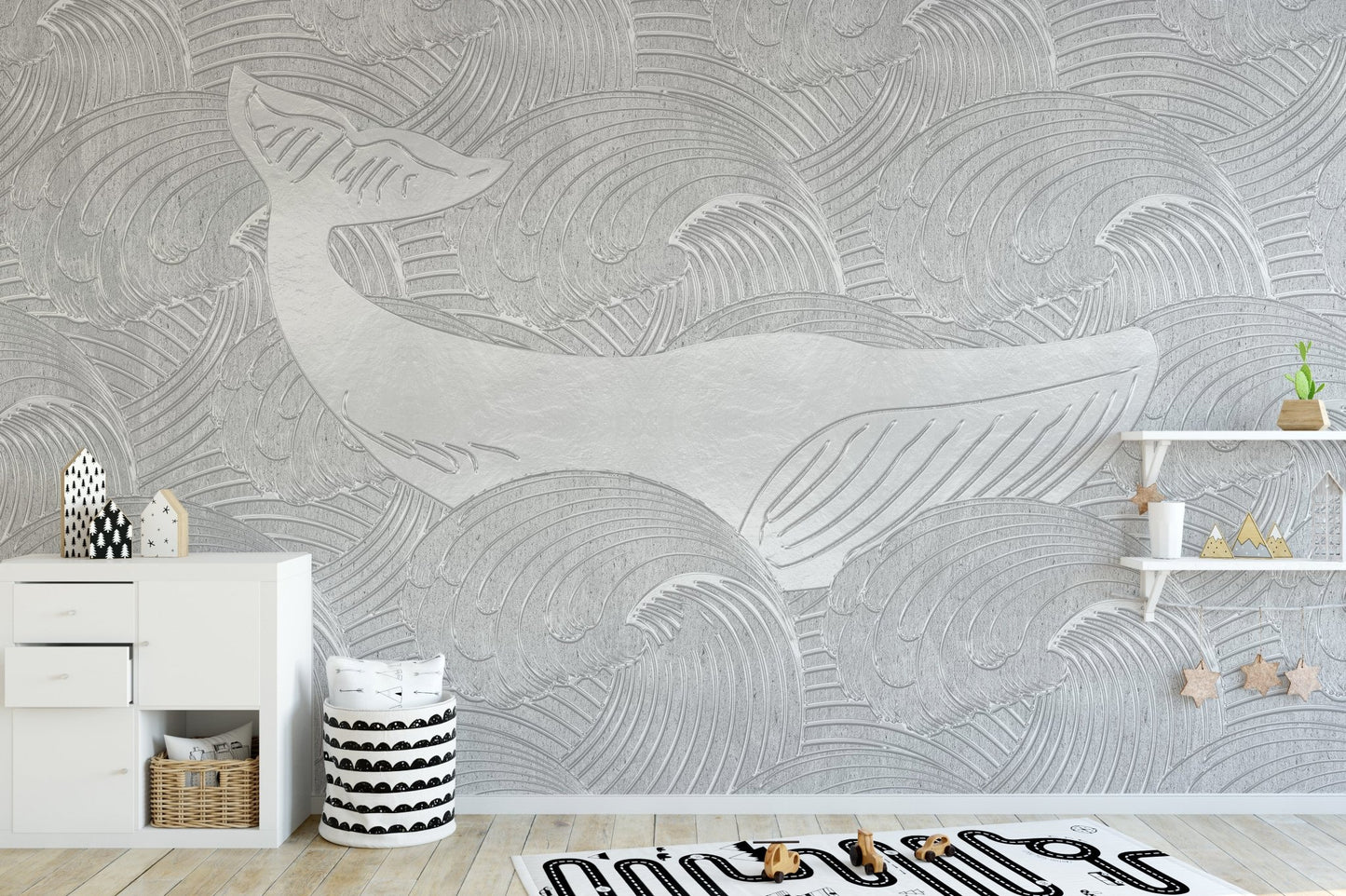 Grey whale wall mural in a play area with a low storage cabinet.