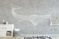 Grey whale wall mural in a play area with a low storage cabinet.