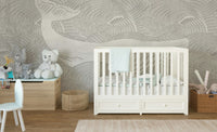 Minimalist whale wall mural in a nursery room featuring a white crib.