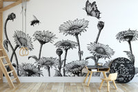 Hand-drawn sunflower wall mural in a minimalist nursery with a wooden crib.