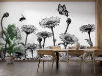 Black and white floral field wall mural behind a wooden dining table and chairs.