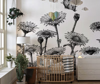 Monochrome botanical sketch wall mural in a bright bedroom with neutral bedding.